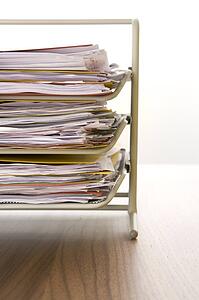 A Stack Of Paperwork Sitting In A Tray