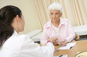 Woman in doctor's office frowning