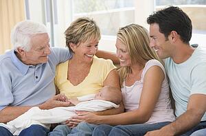 Family in living room with baby smiling