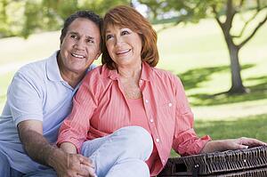 Couple at a picnic holding hands and smiling