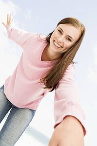 Woman in a pink sweater posing