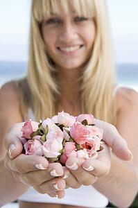 Woman holding a handful of roses