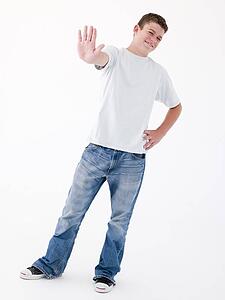 Teenage boy standing with hand up