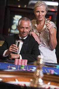 Couple in casino playing roulette and smiling (selective focus)