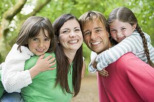 Family outdoors smiling