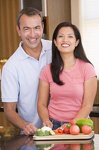 Husband And Wife Preparing meal, mealtime Together