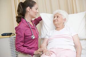 Doctor giving checkup to woman in exam room