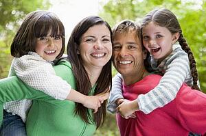 Family outdoors smiling