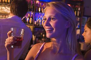 Young woman in a bar with friends