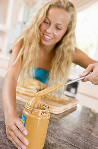 Teenage Girl Making Peanut Butter Sandwich