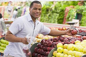 Man shopping for apples at a grocery store