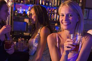 Young woman in a bar with friends