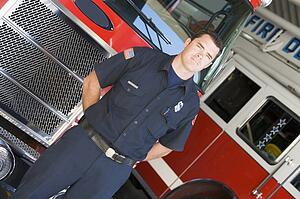 Fireman standing in front of fire engines