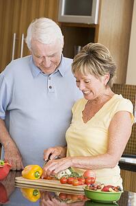 Husband And Wife Preparing Vegetables