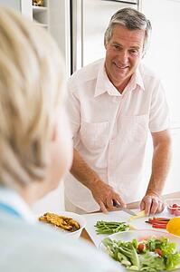 Husband Talking To Wife While Preparing meal, mealtime
