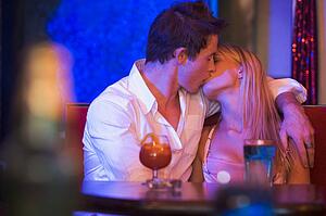 Young couple kissing in a bar