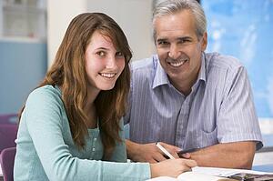 Teacher giving personal instruction to female student