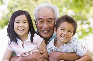Grandfather posing with grandchildren.