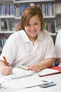 Student writing and studying
