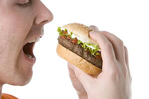 Man About To Bite Into A Cheeseburger