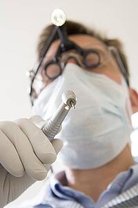 Dentist holding drill