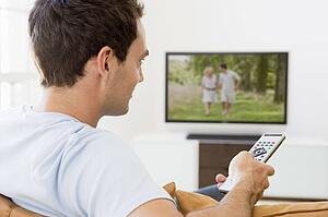 Man in living room watching television