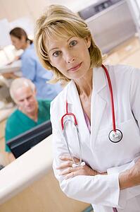 A Doctor And Nurses In The Reception Area Of A Hospital