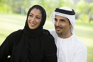 Couple outdoors in park smiling (selective focus)