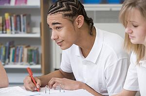 Student writing and studying