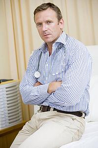 A Doctor Sitting On A Hospital Bed