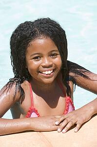 Young girl in swimming pool smiling