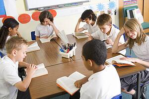 Students in class reading books