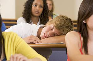 Student in class sleeping (selective focus)