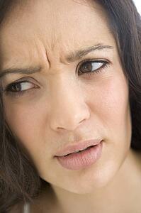 Head shot of woman scowling