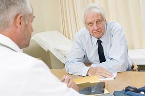 Man in doctor's office frowning
