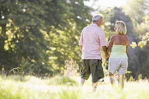Couple walking in park holding hands