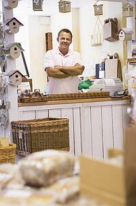 Man in birdhouse store smiling