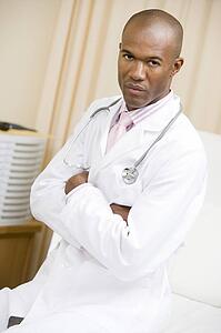 A Doctor Sitting On A Hospital Bed