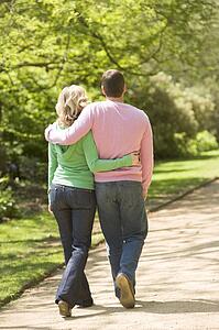 Couple walking on path arm in arm