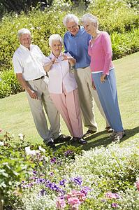 Two senior couples in a flower garden