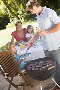 Family Enjoying A Barbeque
