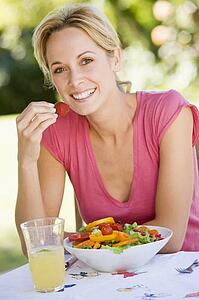 Woman Enjoying A Salad In A Garden