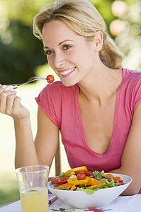 Woman Enjoying A Salad In A Garden