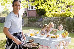 Family Enjoying A Barbeque