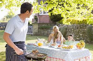 Family Enjoying A Barbeque