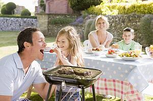 Family Enjoying A Barbeque