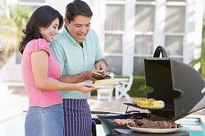 Couple Cooking On A Barbeque