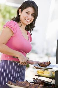 Woman Cooking On A Barbeque