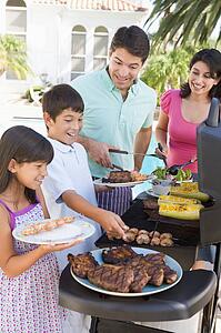 Family Enjoying A Barbeque