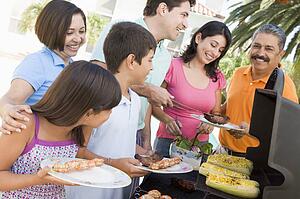 Family Enjoying A Barbeque